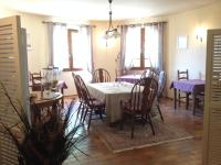 a dining room with a table with purple tables and chairs at Logis du Comte in Suze-la-Rousse