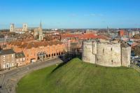 an old castle on top of a green hill at Hilton York in York