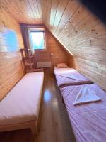 A bed or beds in a room at Chata Drevenica Orava