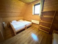 A bed or beds in a room at Chata Drevenica Orava