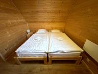 A bed or beds in a room at Chata Drevenica Orava