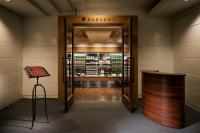 a bar in a room with a door to a liquor store at Shizukuishi Prince Hotel in Shizukuishi