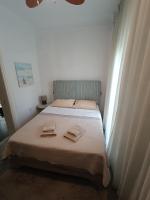 A bed or beds in a room at Sea View Palio Apartment