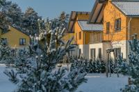 ein schneebedeckter Baum vor einem Gebäude in der Unterkunft Ferienpark Rübezahl am Müggelsee, Haus 20 Mohn mit eigener Sauna, idealer Ort für Natur- und Erholungssuchende, für Radfahrer und Familien mit Kindern in Berlin