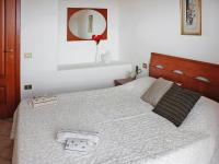 A bed or beds in a room at Holiday homes in Santa Margherita di Pula