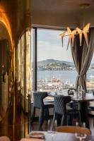 a dining room with a view of the ocean at SO/ Auckland in Auckland
