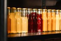 a row of different colored bottles on a shelf at SO/ Auckland in Auckland