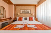 una habitación de hotel con una cama con dos toallas de cisne en Crystal Hotel Varese, en Varese