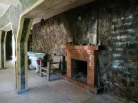 una chimenea de ladrillo en una habitación con fregadero en Hill Guesthouse - Wine Cellar, Fish Farm & Organic Cuisine, en K'eda