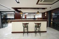 a kitchen with two bar stools at a counter at Midyat Assyria Hotel in Midyat