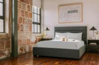 ein Schlafzimmer mit einem Bett und einer Ziegelwand in der Unterkunft Sonder by Marriott Bonvoy The Schaeffer Apartments French Quarter in New Orleans