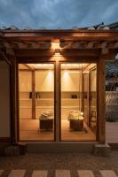 ein Zimmer mit einem Glasfenster mit einer Terrasse in der Unterkunft Nostalgia Hanok Hotel in Seoul