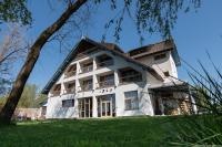 a large white building on a grass field at LivingIn Delta - Casa de Vacanta in Crisan
