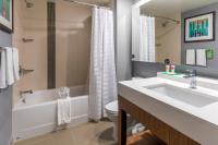 a bathroom with a sink and a tub and a toilet at Hyatt Place Boise/Downtown in Boise