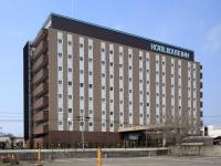 Un edificio de hotel con un cartel encima. en ​Hotel Route-Inn Ube​, en Ube
