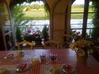 a table with a red and white checkered table cloth at Riverside Home Cottage in Trèbes