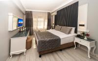 A bed or beds in a room at Beyazit Palace Hotel