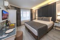 A bed or beds in a room at Beyazit Palace Hotel