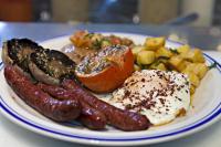 a plate of breakfast food with eggs sausage and potatoes at 54 Queen's Gate Hotel in London