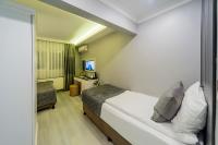 A bed or beds in a room at Beyazit Palace Hotel