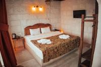 Postel nebo postele na pokoji v ubytování Cappadocia Snora Cave