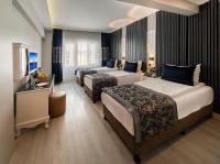 A bed or beds in a room at Beyazit Palace Hotel
