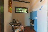 a room with a chair and a blue cabinet at Pousada Vila Tamarindo Eco Lodge in Florianópolis