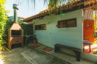 a house with a stove and a bench next to it at Pousada Vila Tamarindo Eco Lodge in Florianópolis