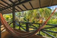 a hammock on the balcony of a resort at Pousada Vila Tamarindo Eco Lodge in Florianópolis