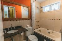 a bathroom with a sink and a toilet and a bath tub at Pousada Vila Tamarindo Eco Lodge in Florianópolis
