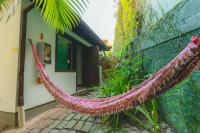 a hammock leaned against a wall next to a building at Pousada Vila Tamarindo Eco Lodge in Florianópolis