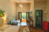 a bedroom with a bed and a desk and a bathroom at Pousada Vila Tamarindo Eco Lodge in Florianópolis