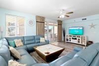 ein Wohnzimmer mit einem blauen Sofa und einem Fernseher in der Unterkunft Ariel Dunes II 101 in Destin