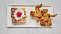 a plate of food with waffles and a raspberry on it at Luxury Downtown Dallas Stay by Amyfinehouse in Dallas