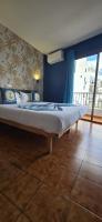 A bed or beds in a room at Hostal Baleàric