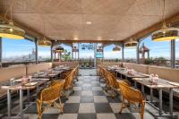 a restaurant with tables and chairs and views of the city at Hari Om Residency 200 Meters From Ram Mandir Ayodhya in Ayodhya