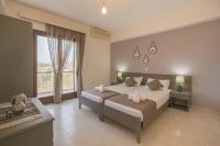 Un dormitorio con dos camas y una gran ventana. en Rhodes Archaggelos Retreat-Nest Among Garden, en Archangelos