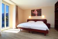 Postel nebo postele na pokoji v ubytování Hotel Elvezia Ascona