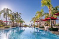 a pool with palm trees and umbrellas at a resort at Four Seasons Hotel in Limassol