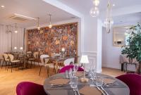une salle à manger avec des tables, des chaises et un mur dans l'établissement Les Cottages du Limonay, à Saint-Méloir-des-Ondes
