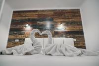 two towels in the shape of a heart in front of a mirror at Insomnia Studio in Drobeta-Turnu Severin