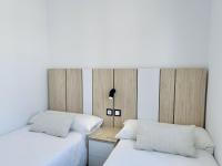 Postel nebo postele na pokoji v ubytování Apartamentos Turísticos Santo Rostro