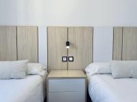 Postel nebo postele na pokoji v ubytování Apartamentos Turísticos Santo Rostro