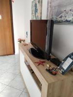 Televízia a/alebo spoločenská miestnosť v ubytovaní Casa Amaranto