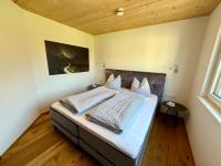 A bed or beds in a room at Alpenapart Singer - contactless check-in