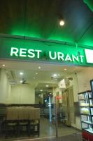 a restaurant with a green sign on the front of it at KVP GOLDEN INN in Tirupati