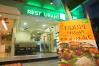 a sign in front of a restaurant with food at KVP GOLDEN INN in Tirupati