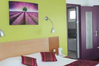 a bedroom with a bed and a painting on the wall at Hotel Bristol in Chalons en Champagne