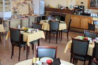 a dining room with tables and chairs in a restaurant at Hotel Bristol in Chalons en Champagne