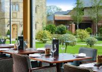 a group of tables with wine glasses on a patio at Stanley House Hotel & Spa in Blackburn